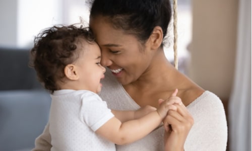 Mum and baby giggling